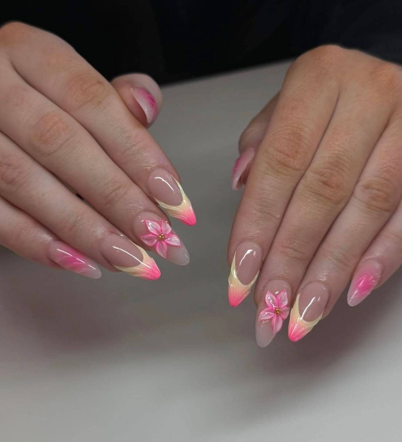 Pink French tips with a gold accent